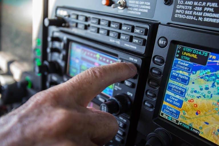 A pilot adjusting a setting on his instrument display - Recurrent Training