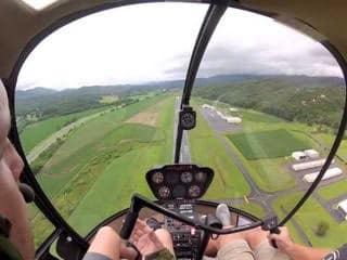 The view from inside the cockpit of a Robinson R22 Helicopter.