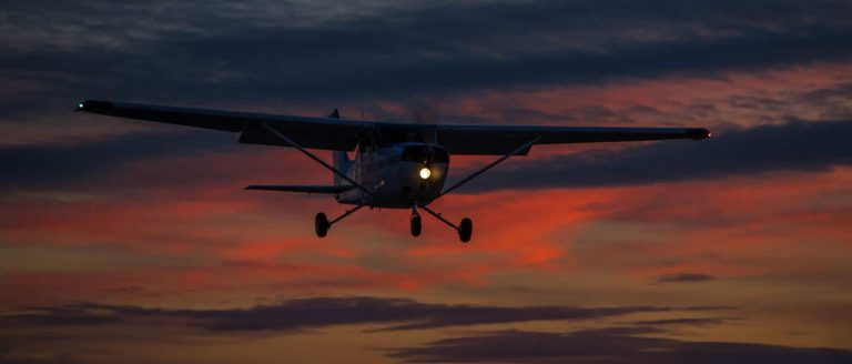 A small Cessna aircraft enjoying some night flying.